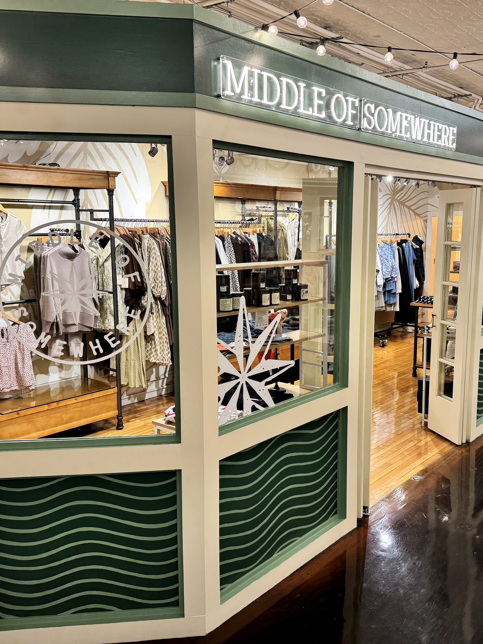The green and cream Middle of Somewhere storefront inside Thornes Marketplace